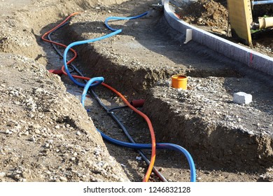 Laying a fiber optic cable for fast internet, Electricity and telephone cable along a new street. Cable Installation power lines at city street, industrial electricity and communication concept.