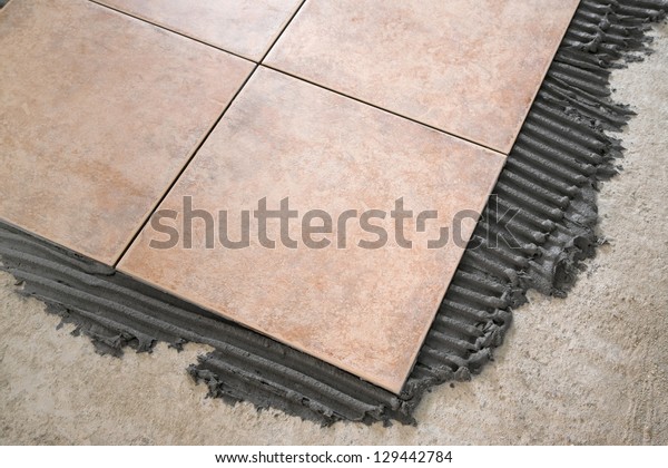 laying floor\
tiles
