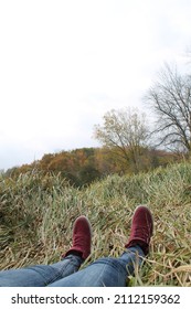 Laying In The Grass With Red High Top Shoes