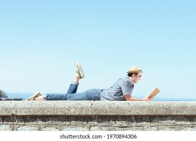 Laying Happy Man Reading A Book In Summer