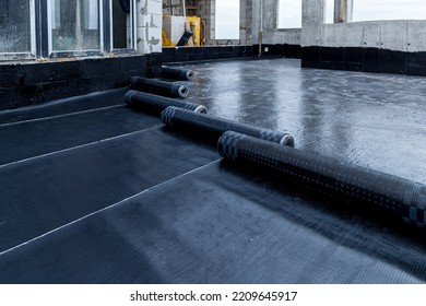 Laying and installation of roofing, bituminous waterproofing of an apartment building. Rolled roofing waterproofing of concrete slabs of stylobate. Heating and melting of bituminous roofing material.