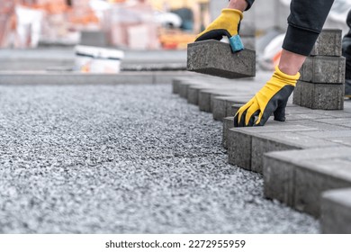 laying interlocking pavers during the construction of sidewalks and roads. copy space
