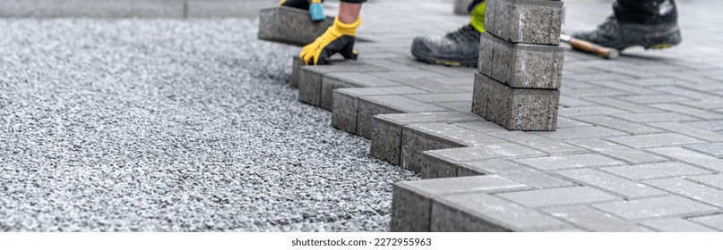 laying interlocking pavers during the construction of sidewalks and roads. banner with copy space
