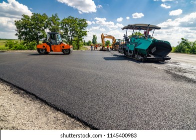 Laying A New Asphalt On The Road. Construction Of The Road.