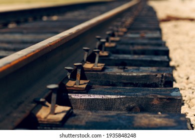 Laying of new railway tracks with wooden sleepers laid on groundwork crushed stone. Railway industry and transport infrastructure.