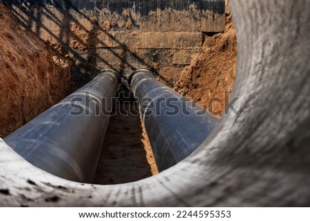 Laying of underground pipes in concrete chamber. Installation of water main at the construction site. Construction of stormwater pits, sewerage valve, sanitary system and pump station