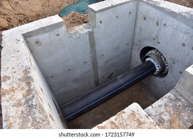 Laying Of Underground Storm Sewer Pipes In Concrete Chamber. Installation Of Water Main At The Construction Site. Construction Of Stormwater Pits, Sewerage Valve, Sanitary System And Pump Station
