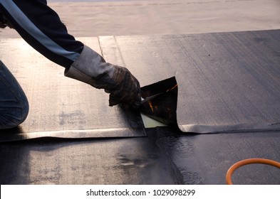 laying of waterproofing sheathing  and insulation during the renovation of a roof in Italy - Shutterstock ID 1029098299