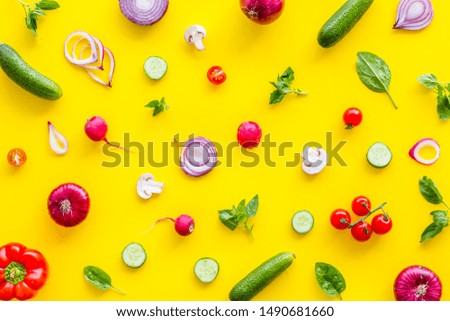Layout of colorful vegetables on yellow background top view pattern