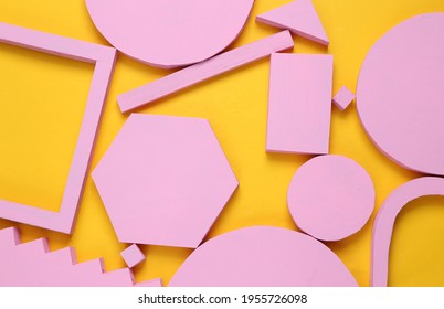 Layout composition of pink geometric shapes on yellow background. Flat lay