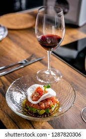 The Layout Of The Finished Dish. Tuna Tartar On A Plate And A Glass Of Red Wine. Master Class In The Kitchen. The Process Of Cooking. Step By Step. Tutorial. Close-up.