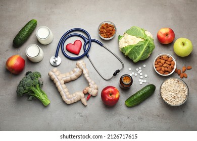 Layout Of Intestine Model And Products To Help Digestion On Grey Table, Top View