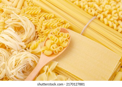 Layout of Italian raw pasta, different types and shapes of pasta, Kinds Farfelle, Spaghetti, Fettucine, Macaroni, Penne, Fusili, Lasagna, durum wheat noodles. - Powered by Shutterstock