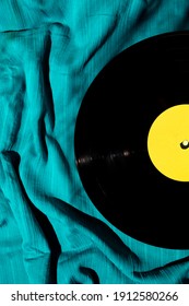 Layout of LP vinyl record on a cyan silk or saten fabric. Old vintage record. - Shutterstock ID 1912580266