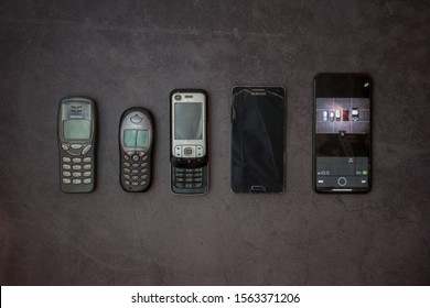 Layout of old phones. Siemens, Samsung, Nokia, iPhone on a gray background. Russia, Tatarstan, October 06, 2019.