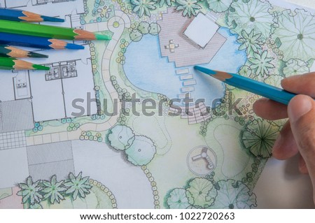 layout plan of home landscape design or garden design drawing by hand with color pencil on white paper and group of color pencils 