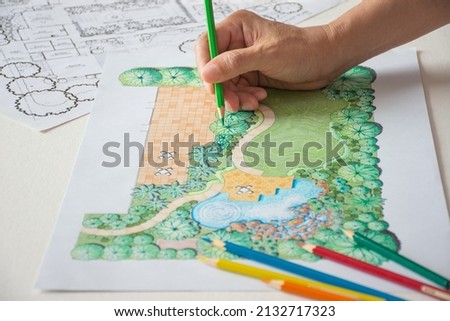 layout plan of house landscape design or garden design or landscape architecture drawing by hand with color marker pens and color pencils on white paper, selective focus