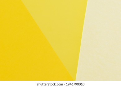 Layout triangles papers in three different shades yellow  Light   dark yellow background  Wallpaper in spring colors  Backdrop for writings  