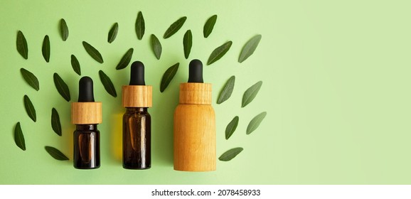 Layout From Zero Waste Cosmetics Bottles On The Trendy Mint Background With Green Leafs Around.Mockup For Cosmetic, Large Banner In Pastel Colors.Organic Concept.