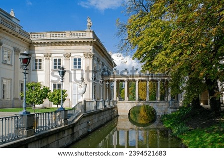 Lazienki Palace architecture in Warsaw, Poland with columns and bridge reflected in the canal
