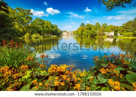 Lazienki Park - Baths Park or Royal Baths also rendered Royal Baths Park is the largest park in Warsaw, Poland. Beautiful lake with flowers.