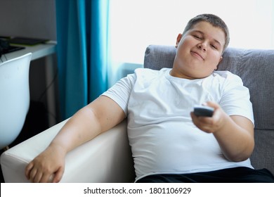 Lazy Child Boy Sit Watching Tv At Home, Passive Overweight Teenager Spend Time Doing Nothing