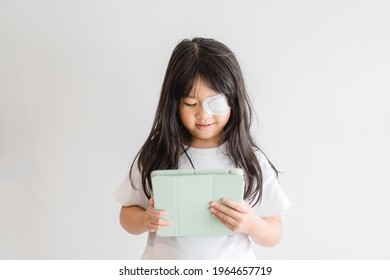 Lazy Eye Amblyopia In Children.Eye Care.Little Asian Girl Covered Up With A Special Patch Online Learning At Home.Occlusion Therapy Using An Eye Patch.Children Care.child Online Learning Education.