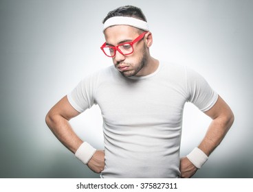 Lazy Funny Sport Man Does Not Wish To Doing Fitness - Exercising.
Isolated On Gray Background. Studio Shot