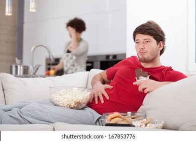 Lazy Guy And His Hard-working Wife In The Kitchen