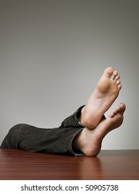 Lazy man with his feet at the table