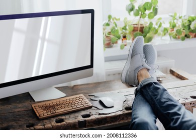 Lazy man putting his feet up on the workstation