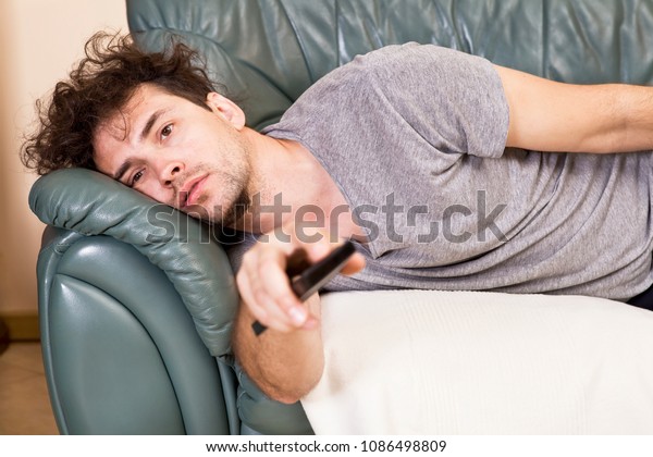 Lazy man with the remote\
on the couch