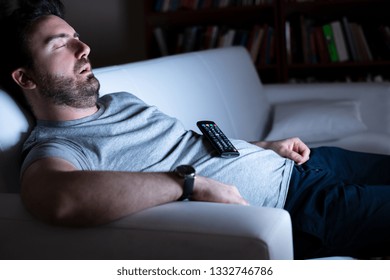 Lazy Man Watching Television At Night Alone