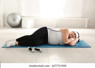 Lazy Overweight Woman Sleeping Instead Of Training On Mat At Gym