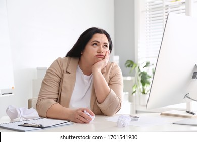 Lazy overweight worker at white desk in office