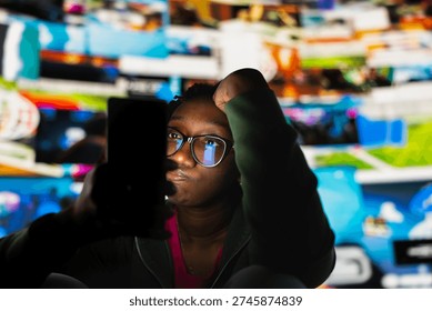 Lazy student using smartphone instead of doing homework, feeling tired and unproductive. Young adult procrastinating with social media app on mobile phone instead of doing school assignments