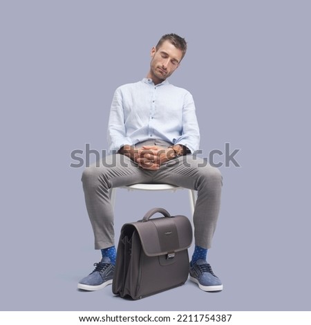 Lazy tired businessman sitting on a chair and falling asleep