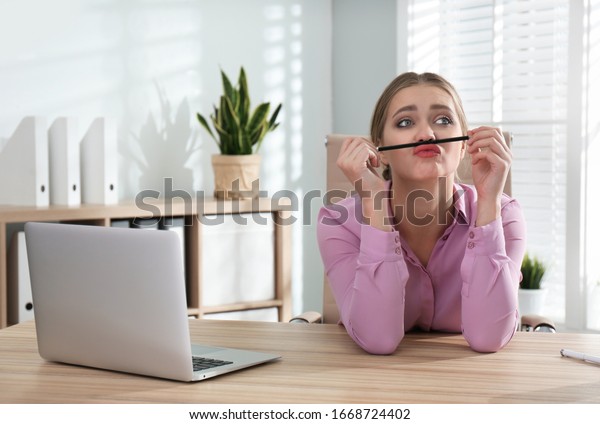 Lazy worker at wooden\
desk in office
