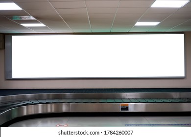 LCD Blank billboard at conveyor belt luggage in airport. Wide screen for cutomer text information advertise about tourism transport business etc. advertising mock up empty in metropolitan