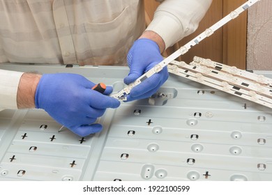 LCD TV Repair. Engineer Assembles LED Board With Lamps For Large Tv Panel.