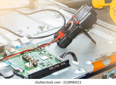 LCD Tv Repair On The Work Table Close Up, Select Focus At Multimeter.