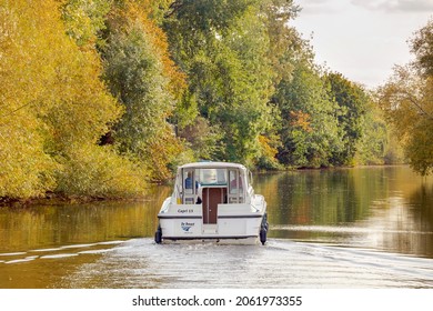 A Le Boat river boat on the river Thames on a sunny autumnal day 12 OCTOBER 2021 in Oxfordshire, UK viewed from a boat, space for text, focus on boat, background soft focus intentionally