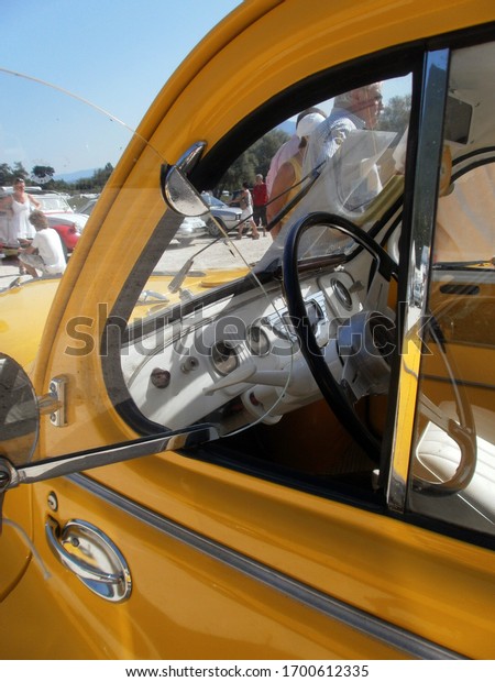 Le Bourget du lac, France - August 19th 2012 :\
Public exhibition of classic cars. Focus on a yellow Renault 4CV\
grand luxe.