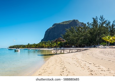 Le Morne, Mauritius - December 11, 2015: Amazing white beaches of Mauritius island. Tropical vacation in Le Morne Beach, Mauritius. Le Morne Brabant mountain in the background.