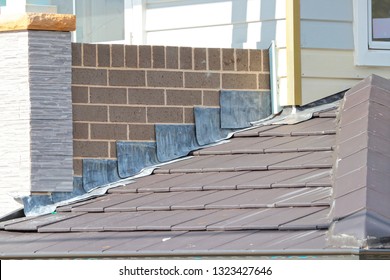 Lead flashing on slate style roof - Shutterstock ID 1323427646