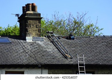 Lead Flashing Workers On A Slate Roof