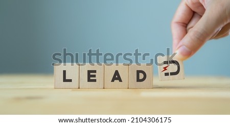 Lead generation concept. Lead customer and cultivation. Inbound marketing strategy. Hand holds wooden cubes with magnet attracts customer icons standing with 
