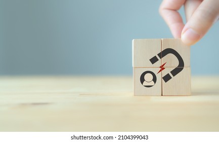 Lead generation, customer retention concept. Inbound marketing strategy. Hand puts wooden cubes with magnet attracts customer icons on beautiful grey background and copy space. Brand loyalty banner. - Shutterstock ID 2104399043