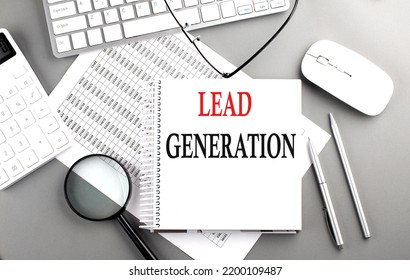 LEAD GENERATION text on a notepad on chart with keyboard and calculator on grey background
