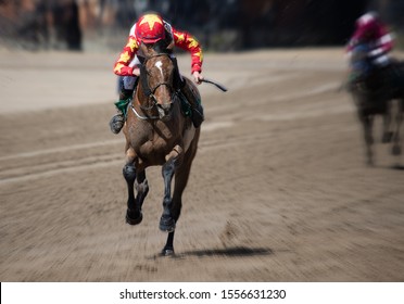 Lead race horse and jockey sprinting towards the finish line, horse racing on the beach, motion blur speed effect